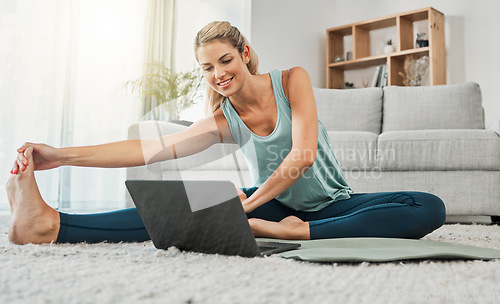 Image of Yoga, stretching and woman on laptop in home streaming training video, web yoga class or tutorial. Zen, health and young female on tech pc, pilates mat and exercise, fitness and wellness workout.