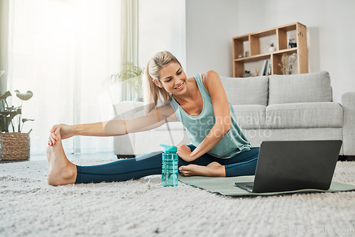 Image of Yoga, zen and stretching woman on laptop streaming training video, web yoga class or tutorial at home. Health, exercise and happy female on tech pc, pilates mat and stretching, fitness and wellness.