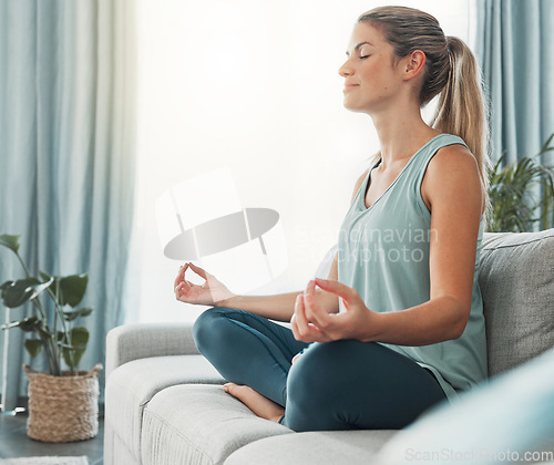 Image of Meditation, yoga and woman doing exercise for fitness, health and peace while sitting in lotus on sofa in lounge at home. Russia female calm and zen during wellness, mindfulness or spiritual practice