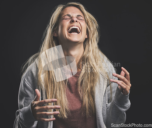 Image of Mental health, crazy and bipolar woman laughing or shouting in dark studio for psychology, depression or identity problem. Drugs addiction, schizophrenia or horror girl psychedelic after abuse