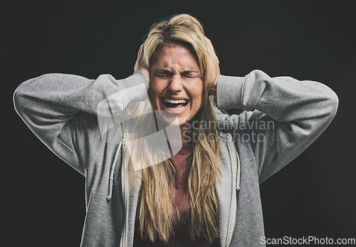 Image of Stress, screaming or crying woman with hands over ears on black background in studio with mental health, anxiety or schizophrenia. Psychology, depression or shouting patient in counseling help asylum