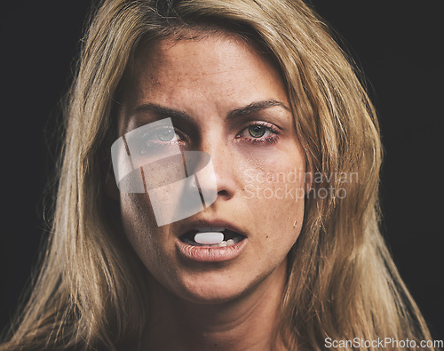 Image of Woman, face and pill for drug in addiction for substance abuse to cure pain and suffering over black studio background. Portrait of female addict or model addicted to medical pills, help and rehab