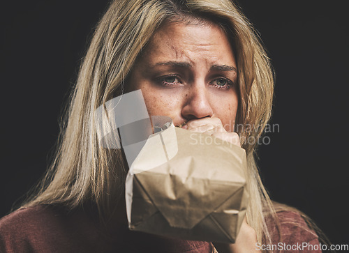 Image of Anxiety, nausea and woman with paper bag for stress and panic attack relief with black mockup. Girl suffering with trauma, psychosis and mental health trouble breath technique for calm mindset.