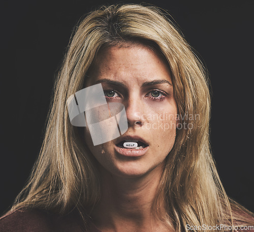 Image of Woman, depression and sad with pills in mouth for mental health, psychology or stress. Girl, anxiety and crying for help with bipolar, paranoid or addiction with medicine in lips for wellness of mind