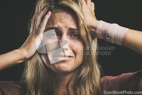 Image of Suicide, depression and sad with a woman victim of violence in studio on a dark background. Anxiety, mental health and pain with a female thinking of death while suffering from pain, hurt or anger