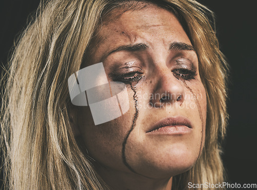 Image of Sad, depression and woman crying with makeup smudge on face from tears with studio wall closeup. Depressed, hopeless and unhappy girl with mental health problem in distress with messy mascara.