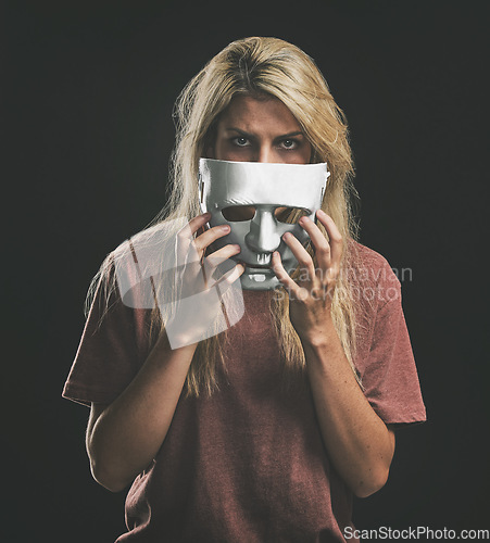 Image of Sad portrait and woman with bipolar mask to hide depression struggle with mockup in studio. Depressed girl hiding identity, emotions and mental health disorder with theatre face disguise.