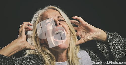 Image of Screaming senior woman, mental health and depression from bipolar anxiety, stress and scary fear on black background. Schizophrenia, psychology and crazy person shout, drugs problem and epilepsy risk