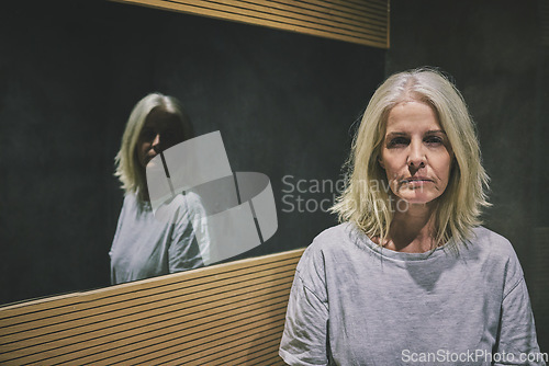 Image of Mature woman, depression or mental health by bathroom mirror of house, home or hotel. Portrait, stress or anxiety of schizophrenia patient in psychology asylum with imposter syndrome, bipolar or fear