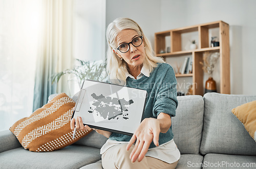 Image of Inkblot test, therapy and mature psychologist talking about mental health problem with a picture on a sofa in an office. Therapist in communication about evaluation, counseling exam and mind health