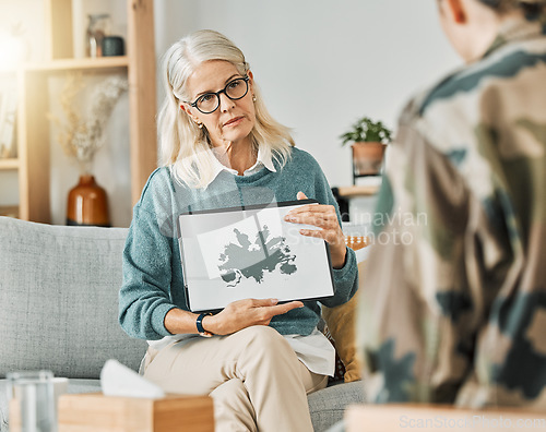 Image of Therapy, evaluation and psychologist talking to a patient about an inkblot picture in an office together. Mature therapist consulting with a client about mental health and counseling with a test