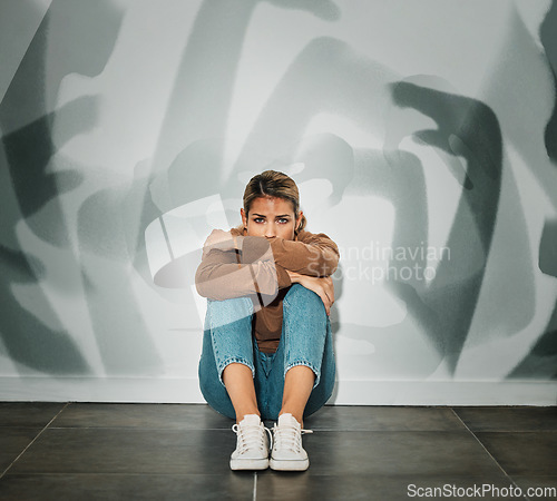 Image of Anxiety, stress and fear of a woman overwhelmed with mental health issues on the floor. Person in a house with depression suffering from distress, sad and busy mind alone isolated in a home depressed