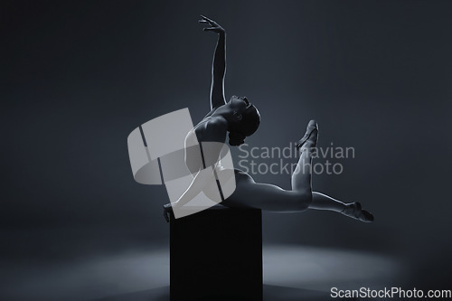 Image of Ballet, dance and woman ballerina in art pose for a theatre or stage performance with a dark background. Young dancer, creative production and artistic mockup, monochrome and rehearsal for show.