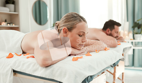 Image of Massage, therapy and relax with a couple in a spa on a bed for wellness, rest or treatment. Luxury, beauty and health with a man and woman lying or relaxing in a health club for body care and peace