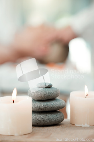 Image of Spa, rock and candle to relax in a room with atmosphere, mood or ambience in a health club. Wellness, luxury and treatment with still life objects on a table in a clinic for rest and relaxation