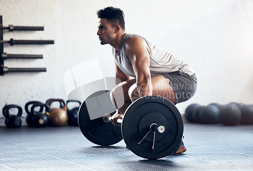 Image of Workout, weightlifting and man doing deadlift training with strength, weights and motivation in fitness gym. Bodybuilder, sport and strong athlete doing power exercise with a dumbbell at health club