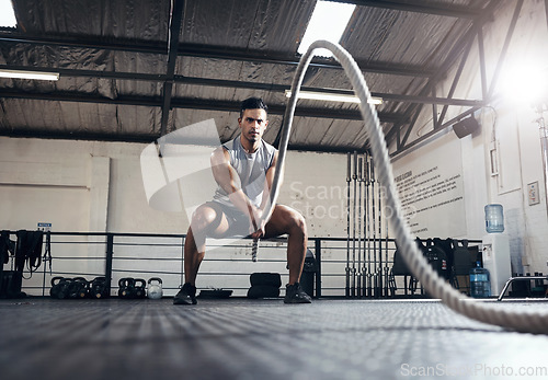 Image of Man, workout and fitness with rope at gym for health, exercise and body wellness. Healthy, muscle and strong for development for athlete in mma, wrestling or sport at training club, class or studio