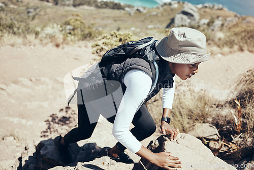 Image of Woman, hiking and rock on mountain for climbing, workout or fitness. Girl, health and exercise for training, sport and wellness on adventure in nature in summer on hill, hiker and stone in Australia