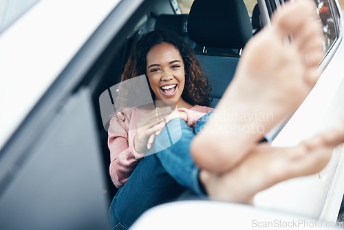 Image of Portrait of woman with feet out window of car, sitting with smile on face. Travel, freedom and weekend holiday on a road for adventure. Young girl, barefoot and happy on roadtrip for summer vacation