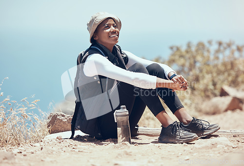 Image of Black woman, view and hiking break on mountains, countryside environment and remote landscape in Namibia. Smile, happy and relax fitness hiker in exercise, training and health workout rest in nature