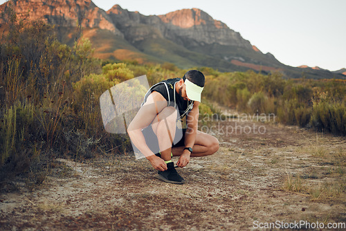 Image of Man, hiking and shoelace on mountain for workout, fitness and run. Shoes, sneakers and male training for sports and health on adventure in summer with wellness, nature and running in Australia