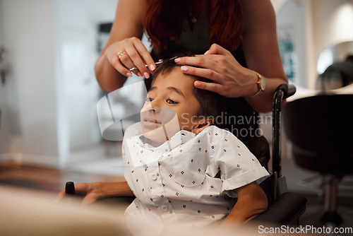 Image of Hairdresser, disability and wheelchair of child with cerebral palsy getting salon hair trim. Young kid with special needs in Mexico getting professional haircut with scissors from hairstylist woman