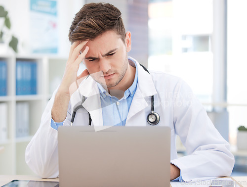 Image of Doctor, computer working and work headache of a man healthcare worker struggling with tech. Medical stress, anxiety and burnout of a hospital or clinic employee using technology with a web glitch