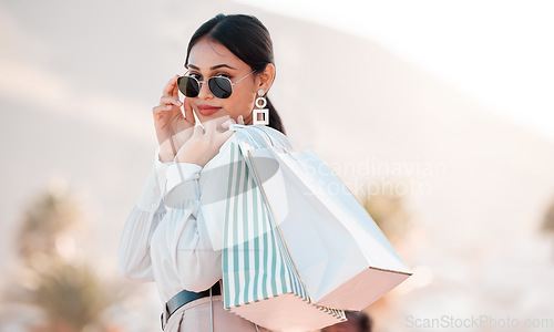 Image of Woman, classy fashion and shopping with bags in luxury designer clothes for wealthy lifestyle. Portrait of a rich female shopaholic or shopper with glasses in travel and retail spree in Puerto Rico