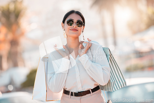 Image of Shopping, wealth and woman on smile for fashion discount, promotion and sales deal in retail market. Freedom, smile and customer or latino female walking with bags of clothes outdoor in Paris, France