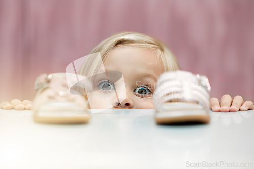 Image of Girl, shoes and shopping with a child customer deciding between footwear for fashion, style or consumerism. Children, retail and option with a kid looking at a sandle and comparing for her wardrobe