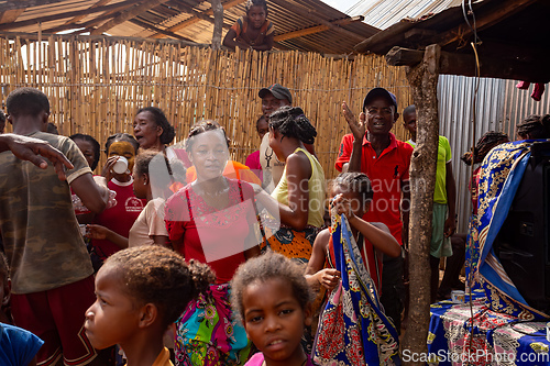 Image of Women in colorful dresses dance at a rural village party in Bekopaka, Madagascar