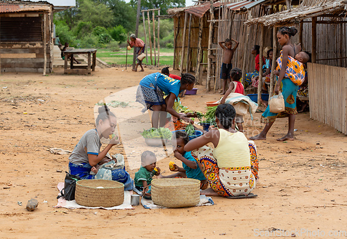 Image of Malagasy woman's with children selling vegetables on the street. Bekopaka, Madagascar