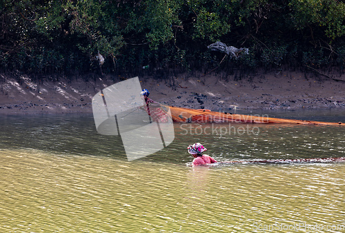 Image of Malagasy woman fishing in a river. Morondava, Madagascar