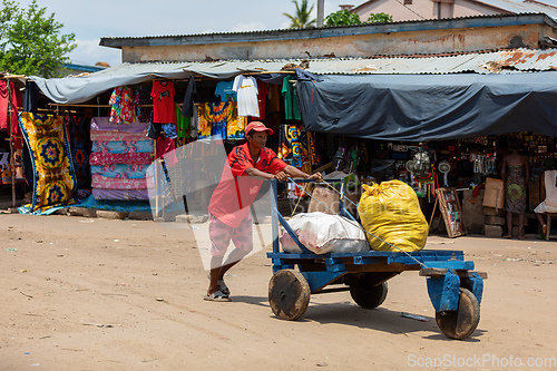 Image of Man pushing cart with bags on street of Miandrivazo in Madagascar