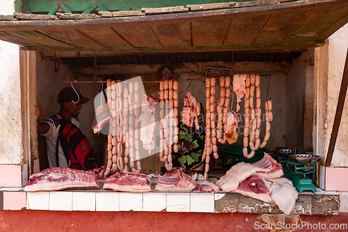 Image of Woman buys meat from a street butchery in Mandoto, Madagascar.