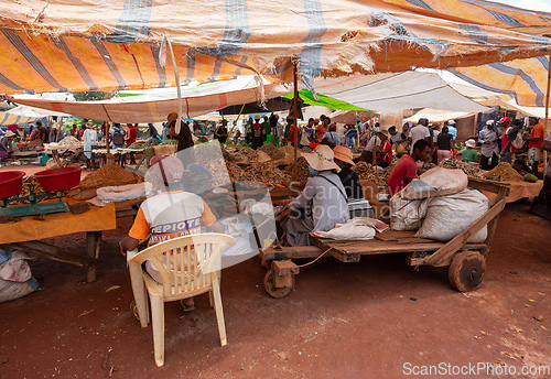 Image of Malagasy man buys dried fish at a street market. Fishing is one of the livelihoods in Madagascar.