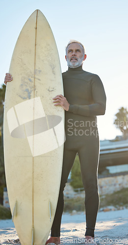 Image of Beach, board and surfer on holiday by the ocean of Costa Rica with idea for adventure in retirement during summer. Mature man surfing on travel vacation by the sea and tropical ocean for health