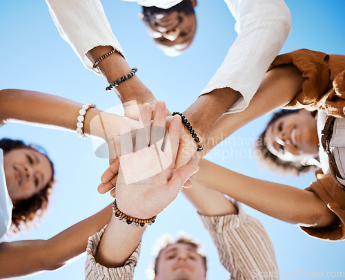 Image of Friends, trust and support hands low angle for solidarity in multicultural group with blue sky. Care, respect and love in friendship with young people who enjoy happy emotional bond together.