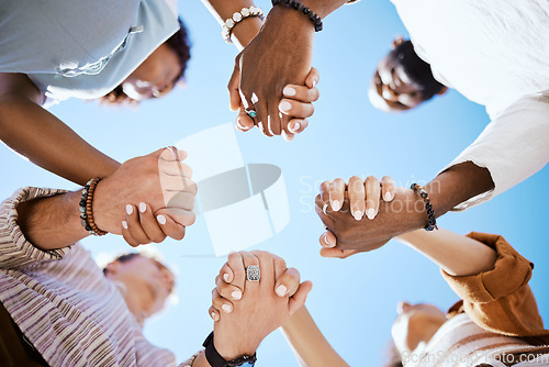 Image of Diversity, support and people holding hands in trust and unity for community against sky background. Hand of diverse group in solidarity for united team building collaboration and teamwork success