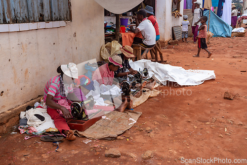 Image of Street tailors work with their outdated manual sewing machines. Earn some money in Madagascar is very difficult