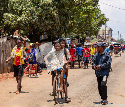 Image of Malagasy Students in uniforms on bike, Mandoto Madagascar