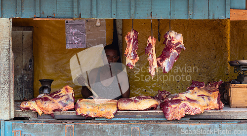 Image of A hot day in Miandrivazo, Madagascar, with a street stall butcher shop open
