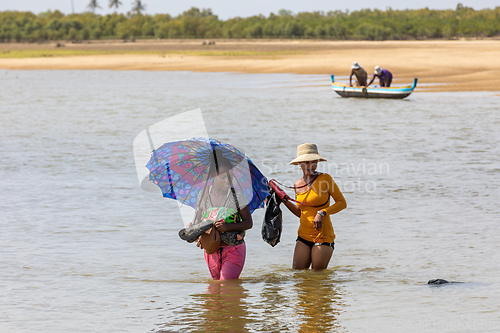Image of Women crosses a river, Morondava, Madagascar