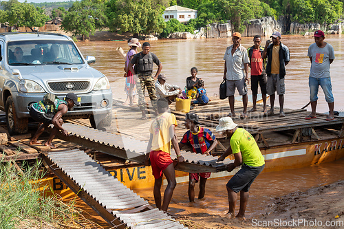 Image of Ferry carrying passengers travels on the Tsiribihina River in Madagascar.