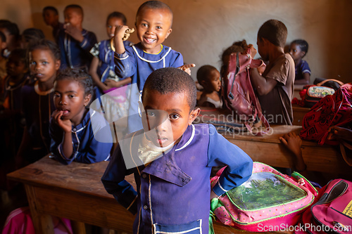 Image of Happy Malagasy school children students in classroom. School attendance is compulsory, but many children do not go to school.