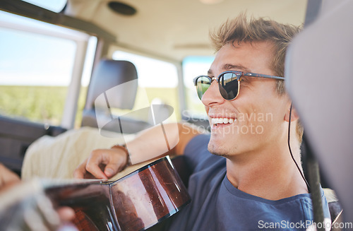 Image of Music, guitar and young man in car on a roadtrip adventure in nature. Summer, holiday and journey on the road, fun musician on vacation. Travel, freedom and explore nature with musical instrument