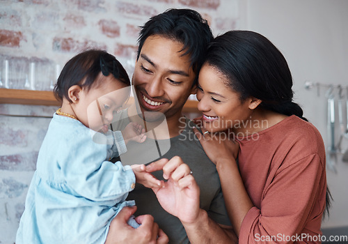 Image of Family with down syndrome baby, happy parents in kitchen home together and young child care. Indian father holding cute kid, asian mother smile with support and bonding happiness in Brazil house