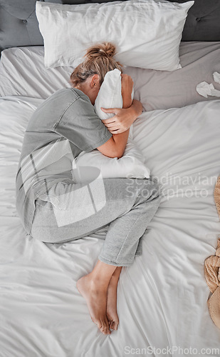 Image of Sad, depression and woman with insomnia after divorce in the bed in house from above. Top view of depressed, tired and sick girl with stress, burnout or mental health problem in the bedroom