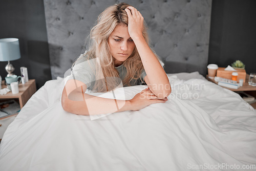 Image of Stress, anxiety and depression, a woman in bed, thinking sad and anxious, too sick too get up. Depressed lady in bedroom with medicine, prescription drugs and pills for mental health care in USA.