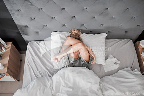 Image of Tired, sad and sick woman in bed with insomnia in the bedroom of house from above. Top view of girl with depression, anxiety and mental health problem thinking of sleep, stress and burnout in home